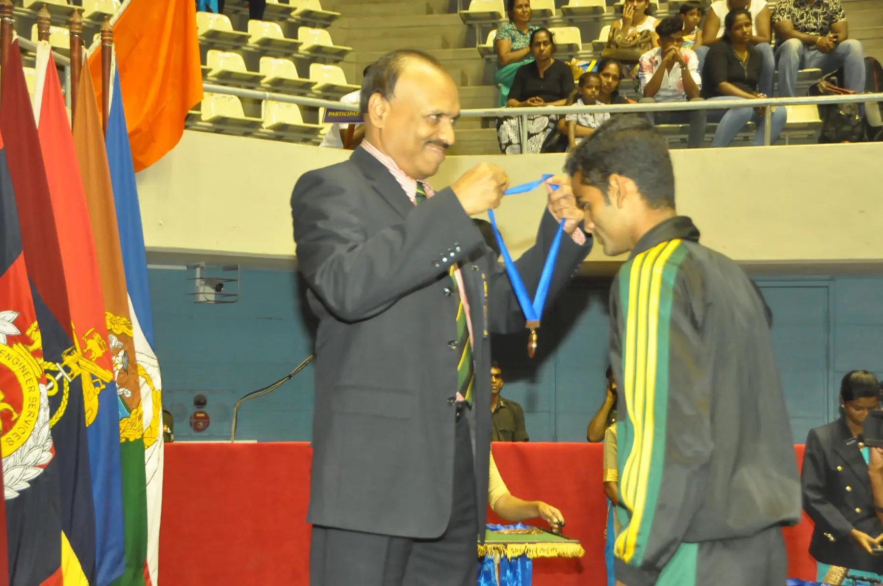 Isuru receiving an Army volleyball medal