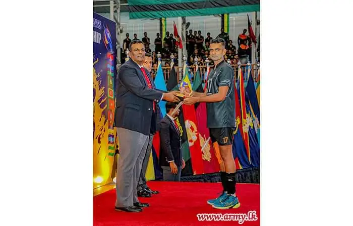 Isuru holding an Army volleyball player award