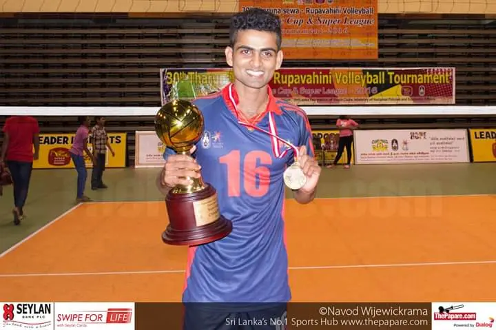 Isuru with a national volleyball trophy