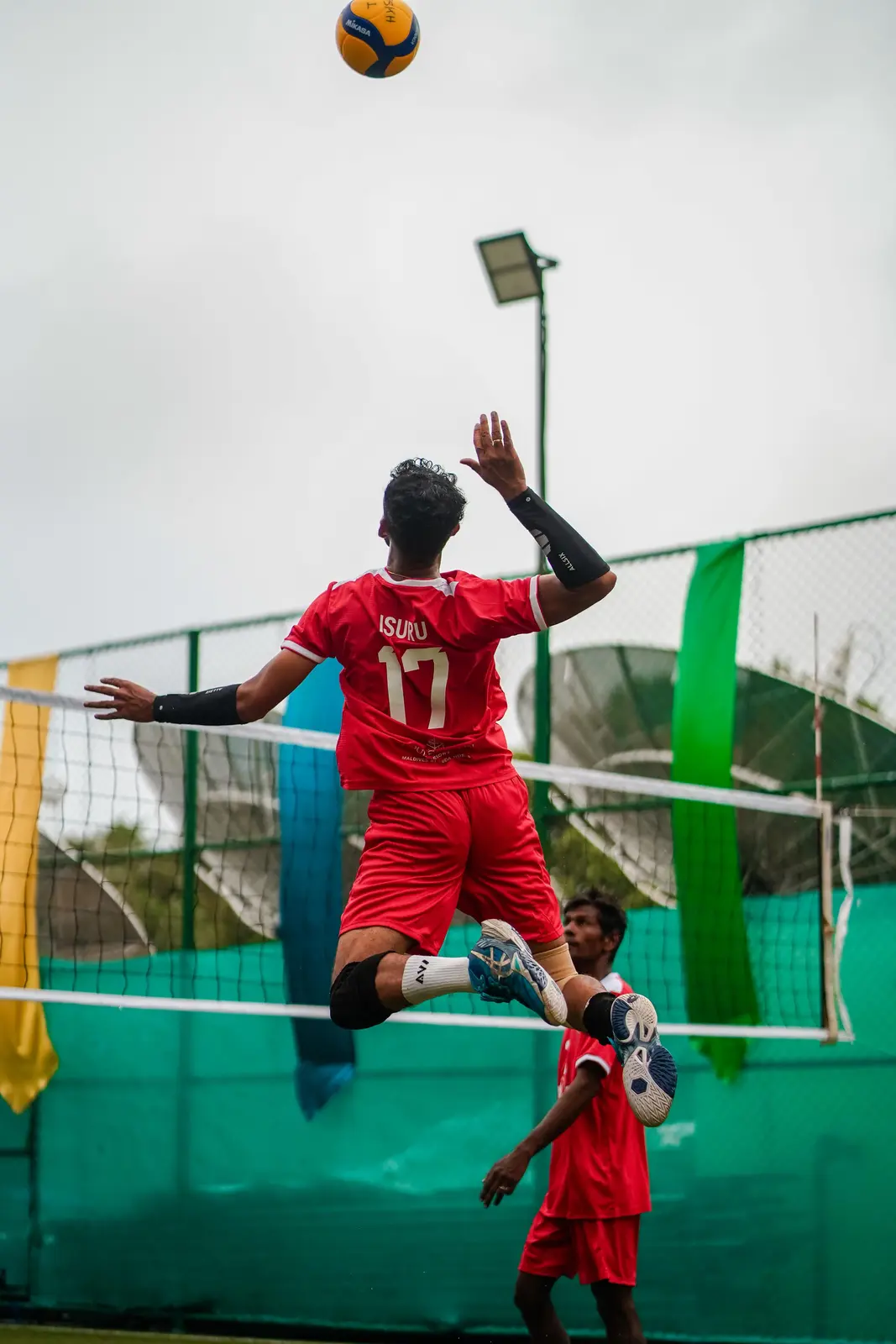 Isuru in red during a resort volleyball match