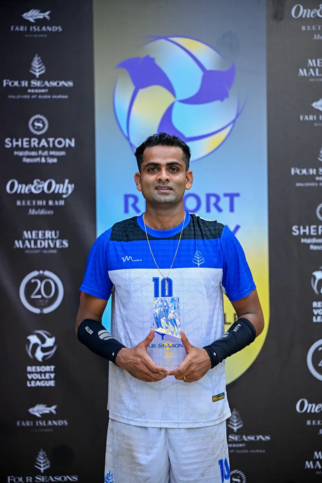 Isuru receiving recognition at a resort volleyball event