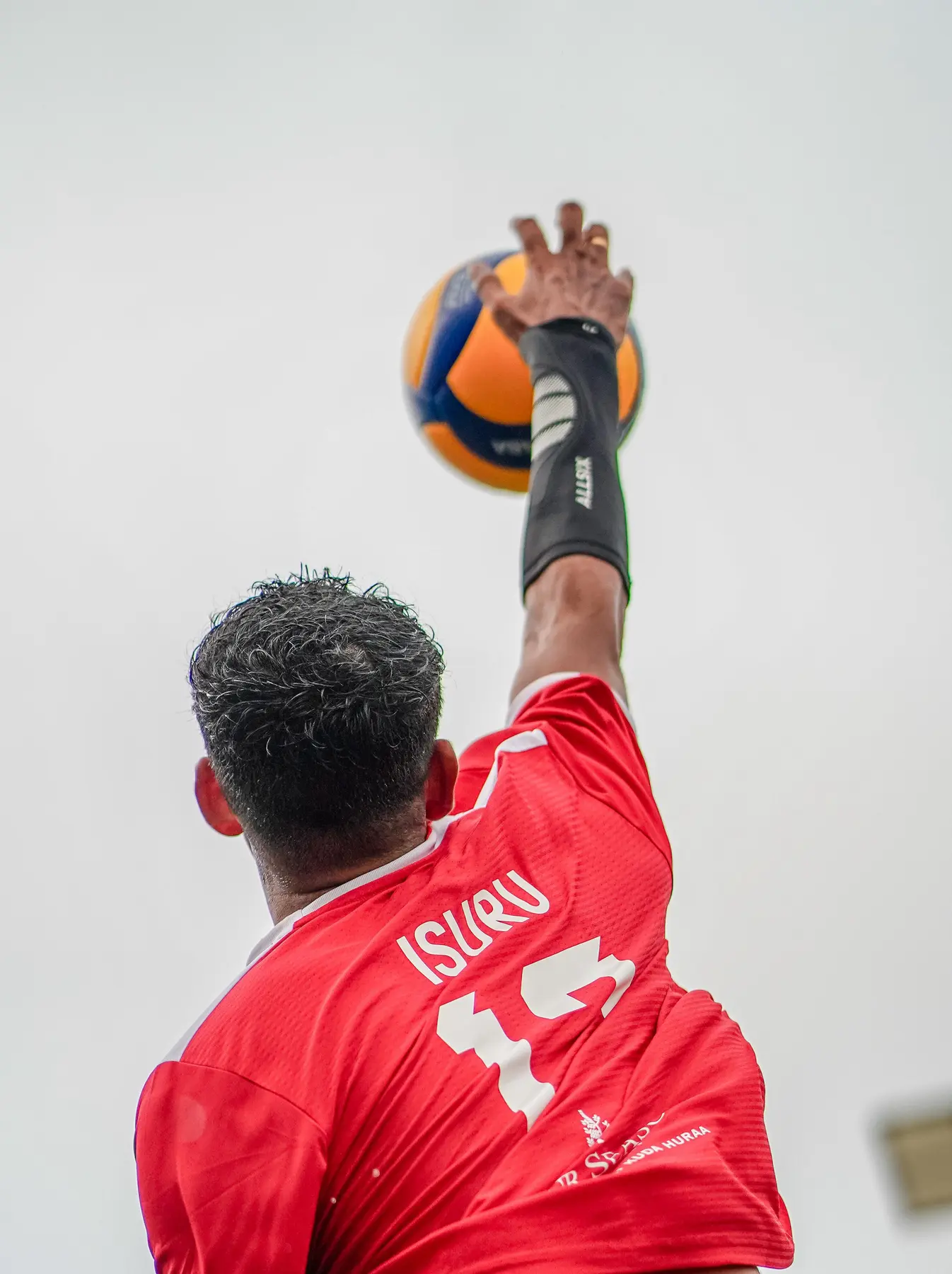 Isuru serving in the resort volleyball league
