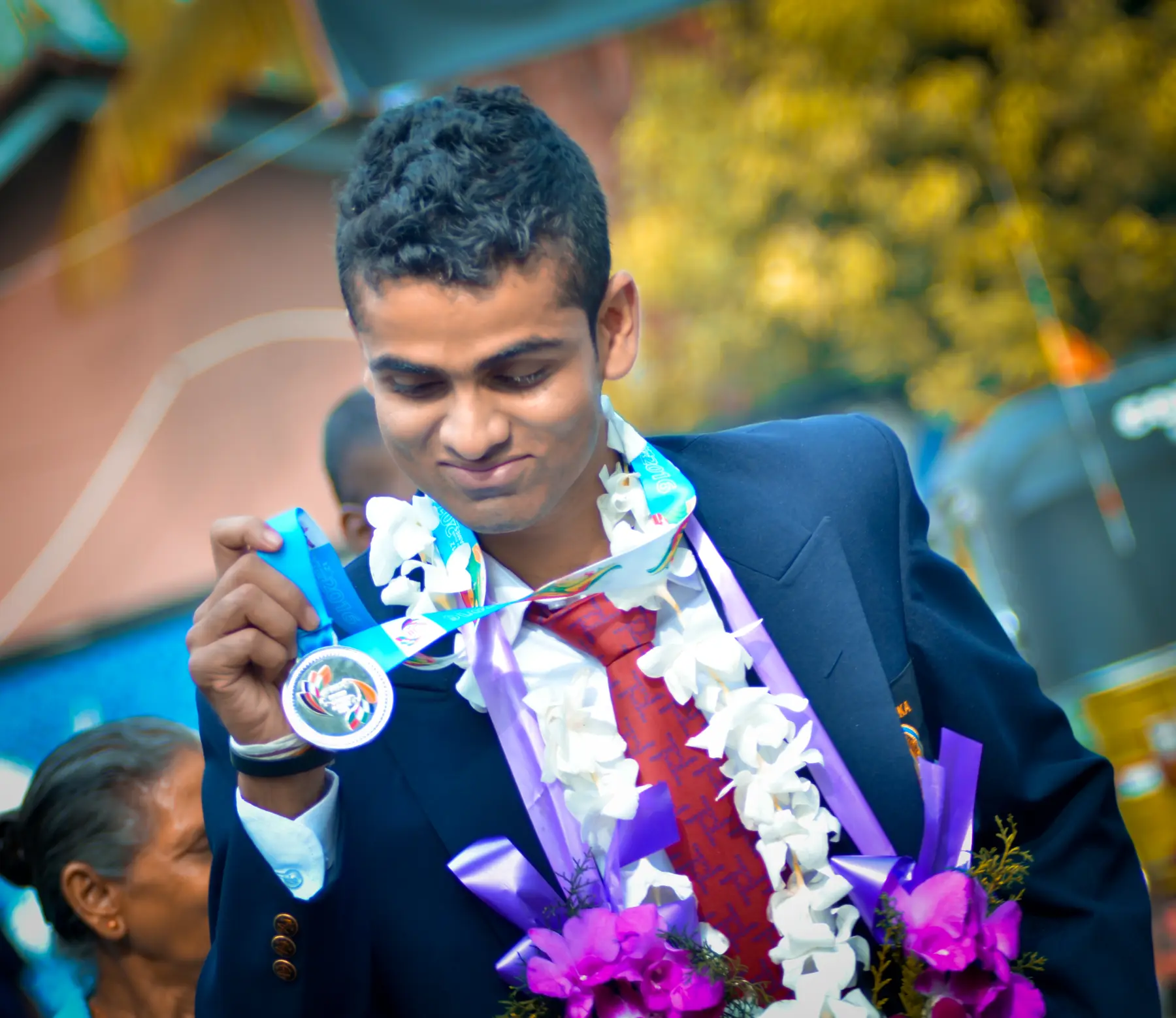Isuru Madhushan holding his South Asian Games silver medal