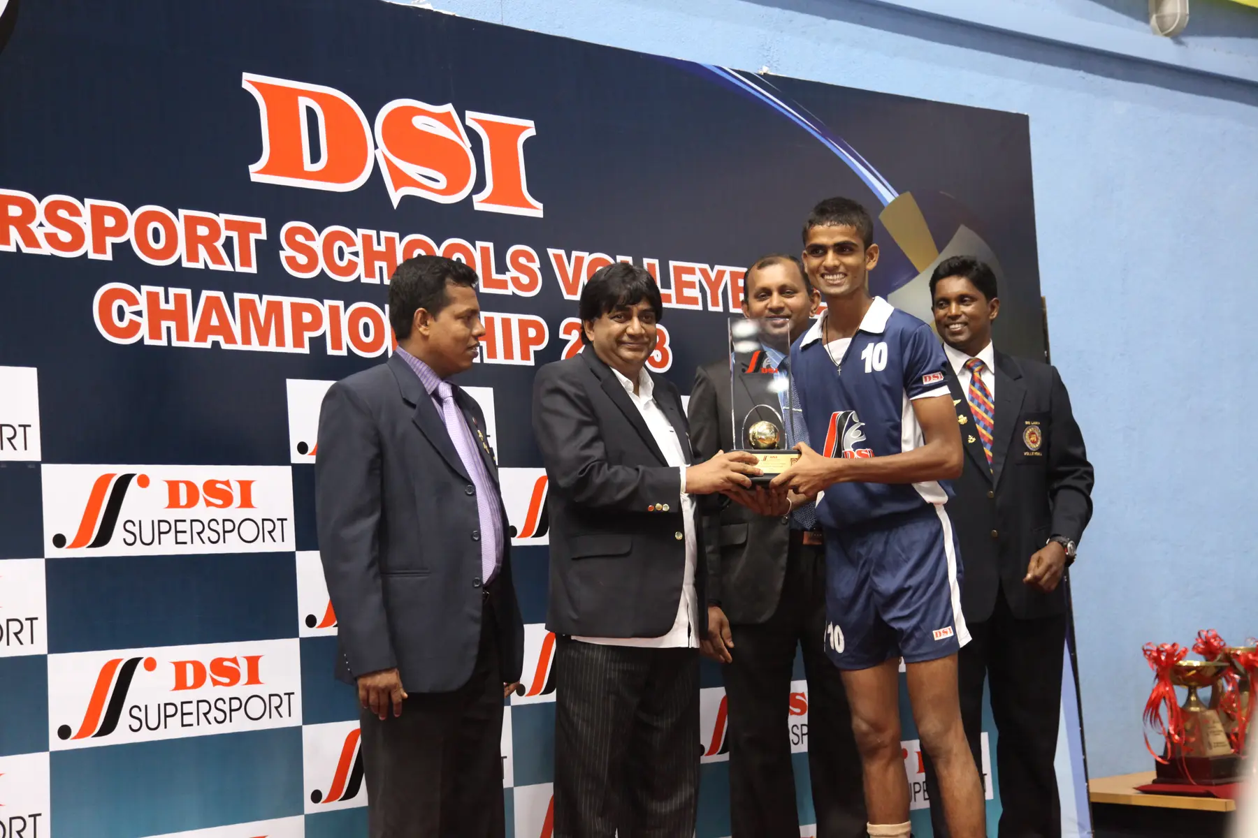 Young Isuru receiving a DSI school volleyball award